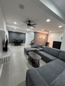 a living room with a couch and a table at Classic Pearl Homestay in Teluk Intan
