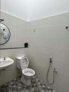 a bathroom with a toilet and a sink at Classic Pearl Homestay in Teluk Intan +37 photos