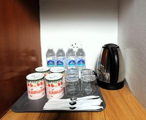 a tray with bottles of water and glasses on a counter at Hotel Putra Hills at WTCKL in Kuala Lumpur