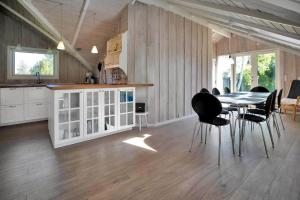 a kitchen and dining room with a table and chairs at 14246-Grevinge-Egenaes-Vaenge-42 in Grevinge