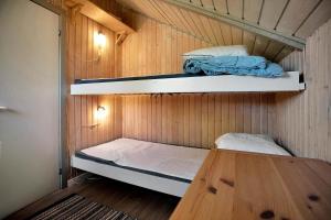 a small room with two bunk beds and a wooden floor at 14246-Grevinge-Egenaes-Vaenge-42 in Grevinge