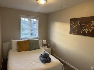 a bedroom with a bed with a stuffed animal on it at Gorgeous 3-Bedroom 3Bathroom house in Kitchener