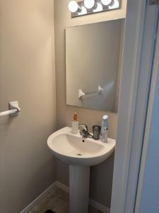 a bathroom with a sink and a mirror at Gorgeous 3-Bedroom 3Bathroom house in Kitchener +14 photos