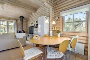 a kitchen and dining room with a table and chairs at 10006-Rorvig-Hojsandsparken-3 in Rørvig +13 photos