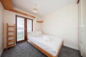 a small bedroom with a bed and a window at Spacious 2BDR Flat Near Portmarnock Beach in Dublin