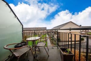 a balcony with a table and chairs on a balcony at Spacious 2BDR Flat Near Portmarnock Beach in Dublin