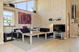a living room with a couch and a table at 16623-Farevejle-Stihojvej-14 in Fårevejle