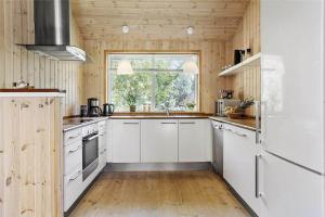 a kitchen with white cabinets and a window at 16623-Farevejle-Stihojvej-14 in Fårevejle