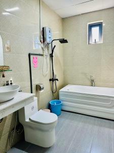 a bathroom with a toilet and a sink and a tub at Healling home 1 in Da Thien +11 photos
