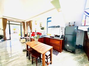 a kitchen with a table with a vase of flowers on it at Healling home 1 in Da Thien