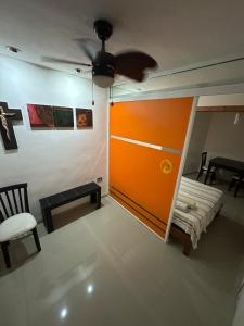 a living room with a large orange door and a couch at Departamento Masha in Tizimín