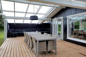 a patio with a table and chairs on a deck at 11136-Nykobing-Sj-Vindingsvej-2 in Nykøbing Sjælland
