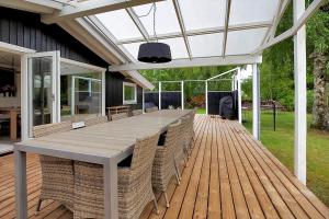 a patio with a table and chairs on a deck at 11136-Nykobing-Sj-Vindingsvej-2 in Nykøbing Sjælland