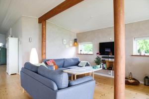 a living room with a blue couch and a table at 14242-Vig-Maglehojvej-6 in Vig