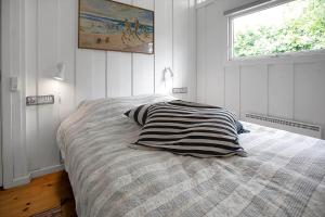 a bedroom with a bed with a pillow and a window at 14242-Vig-Maglehojvej-6 in Vig