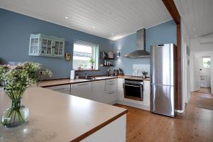 a kitchen with a refrigerator and a vase of flowers at 14242-Vig-Maglehojvej-6 in Vig +22 photos