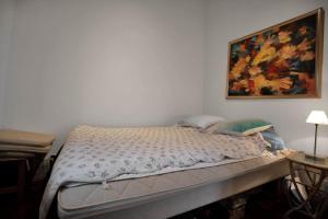 a bed in a bedroom with a painting on the wall at 16624-Farevejle-Stihojvej-25 in Fårevejle