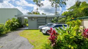 a house with a car parked in the driveway at Villa Aurora with Jacuzzi in La Fortuna in Fortuna