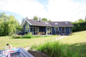 a blue house with a picnic table in front of it at 16624-Farevejle-Stihojvej-25 in Fårevejle