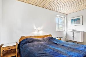 a bedroom with a bed with a blue blanket on it at 13387-Vig-Vej-11-4 in Vig