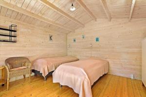 a room with two beds and a chair in it at 13387-Vig-Vej-11-4 in Vig