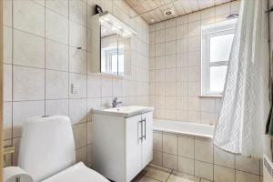 a bathroom with a toilet and a sink and a tub at 13387-Vig-Vej-11-4 in Vig +12 photos