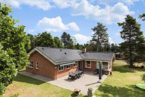 a small brick house with a patio in a yard at 13387-Vig-Vej-11-4 in Vig