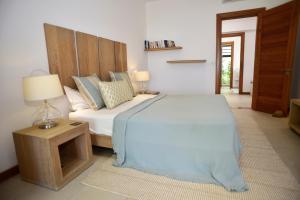 a bedroom with a bed and a table with a lamp at Coral Villa in Cap Malheureux +37 photos