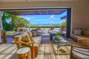 a living room with a couch and a table at Coral Villa in Cap Malheureux