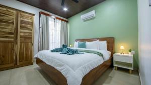 a bedroom with a large bed and a window at Villa Aurora with Jacuzzi in La Fortuna in Fortuna +21 photos
