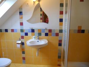 a bathroom with a sink and a toilet at Kertvárosi Vendégház in Orosháza