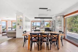 a kitchen and dining room with a table and chairs at Moonraker - Fireplace with Swimming Pool in Broughton Village