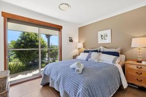 a bedroom with a bed and a large window at Moonraker - Fireplace with Swimming Pool in Broughton Village +27 photos