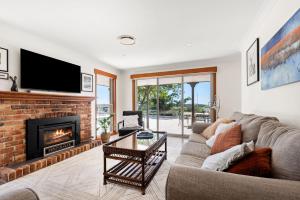 a living room with a couch and a fireplace at Moonraker - Fireplace with Swimming Pool in Broughton Village