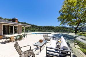 a patio with a couch and chairs and a table at Moonraker - Fireplace with Swimming Pool in Broughton Village