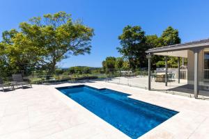 a swimming pool in the backyard of a house at Moonraker - Fireplace with Swimming Pool in Broughton Village