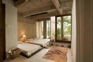 a bedroom with two beds and a large window at The Still Slow & Sip in Nha Trang