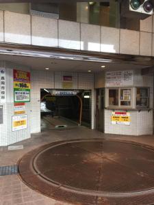 a building with a basketball court in front of a tunnel at Hotel New Green Plaza in Nagaoka