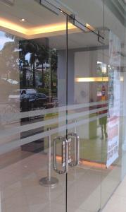 a glass door with a handle in a store window at T-hotel JB in Johor Bahru