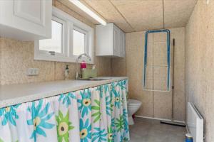 a bathroom with a sink and a shower with a toilet at LF14223-Roslev-Livovej-9 in Roslev +16 photos