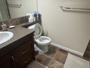 a bathroom with a toilet and a sink at Peace Home in Calgary