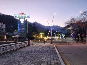 a street with a sign on the side of a road at Seoraksan Youth Hostel in Sokcho