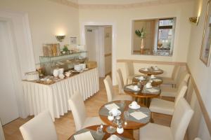 a dining room with two tables and chairs at Classic Inn in Heidelberg
