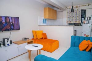 a living room with a couch and a table at Bethany Cushy Home Ltd in Kisii