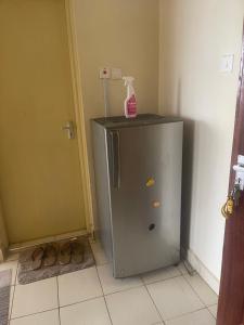 a small refrigerator with a bottle on top of it at The ZEN DEN in Eldoret