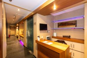 a kitchen with a counter and a tv on the wall at Pera Rose Hotel & SPA in Istanbul