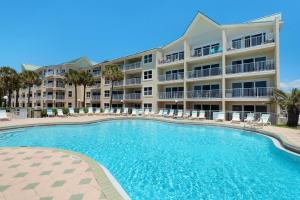 a large apartment building with a large swimming pool at Emerald Gulf Escape at Miramar Beach in Destin