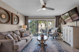a living room with a couch and a table at Emerald Gulf Escape at Miramar Beach in Destin