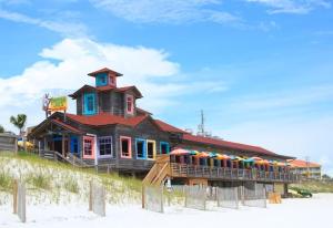 a building on the beach with umbrellas at Emerald Gulf Escape at Miramar Beach in Destin