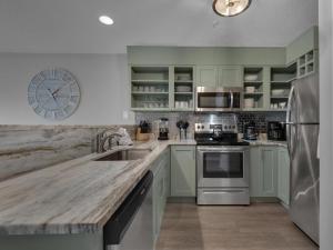 a kitchen with a wooden counter top and a sink at Emerald Gulf Escape at Miramar Beach in Destin